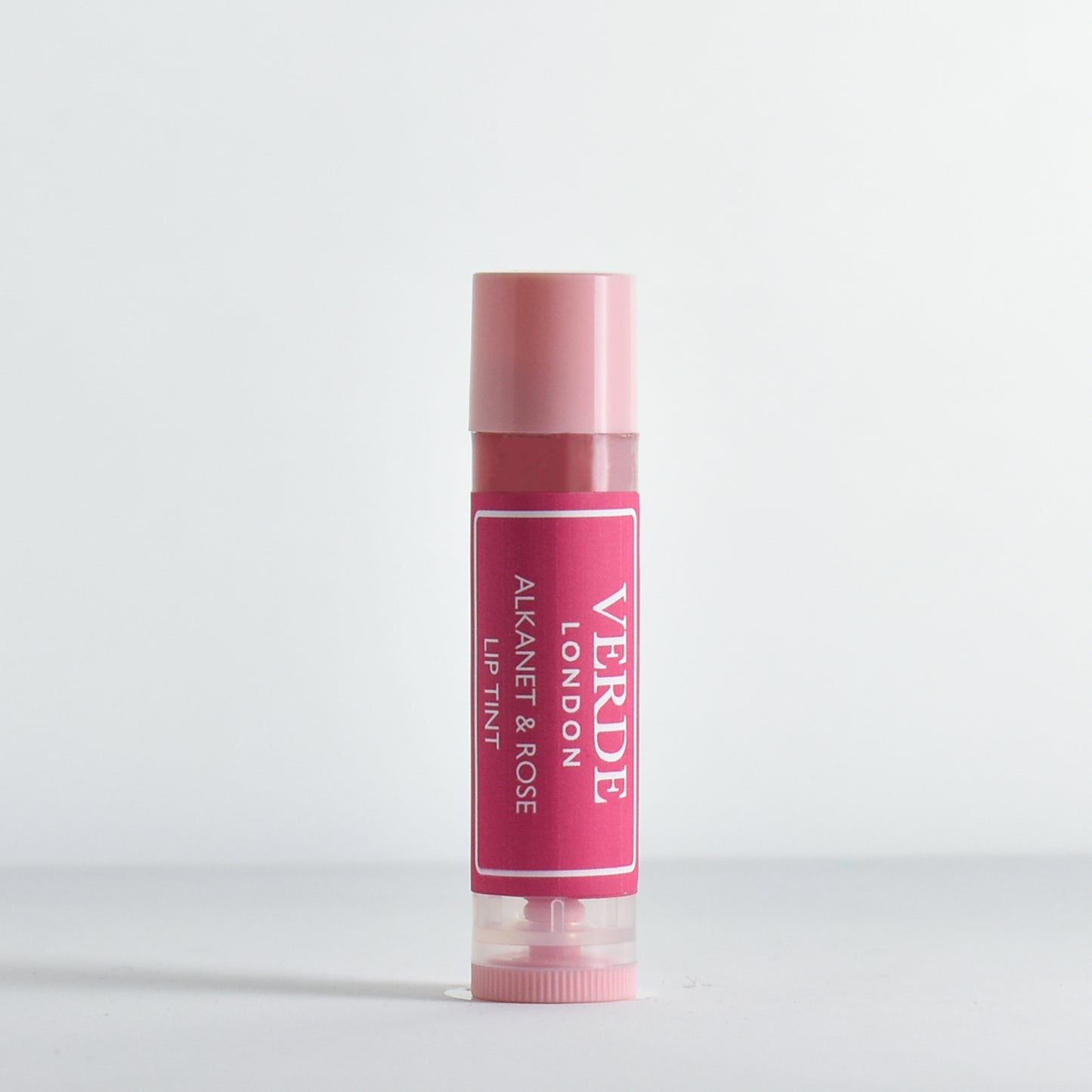 Pink Alkanet and Rose lip tint with visible Verde London brand name on a white background
