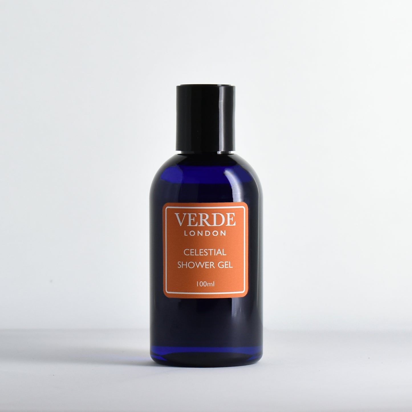 Blue bottle of Verde London Celestial Shower Gel with an orange label on a white background