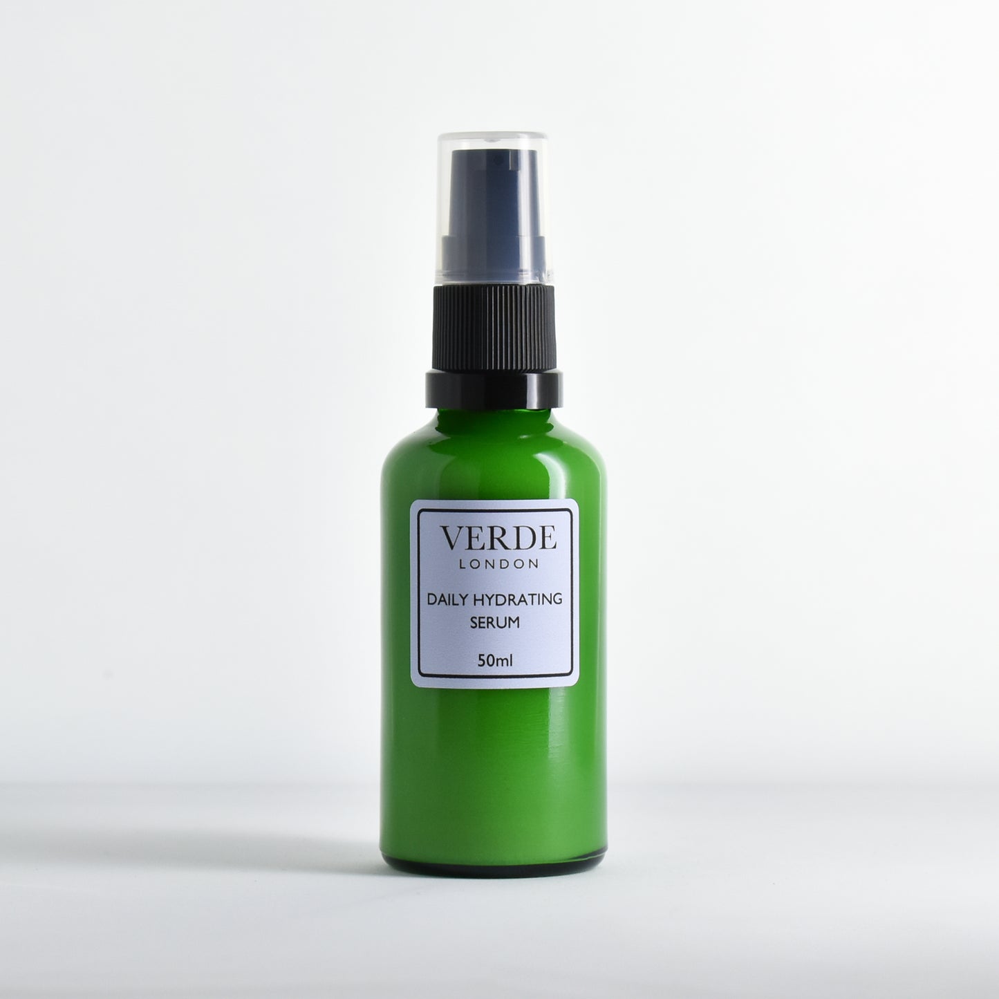 Green Daily Hydrating Serum bottle by the brand Verde London with black pump nozzle with a pale blue label on a white background
