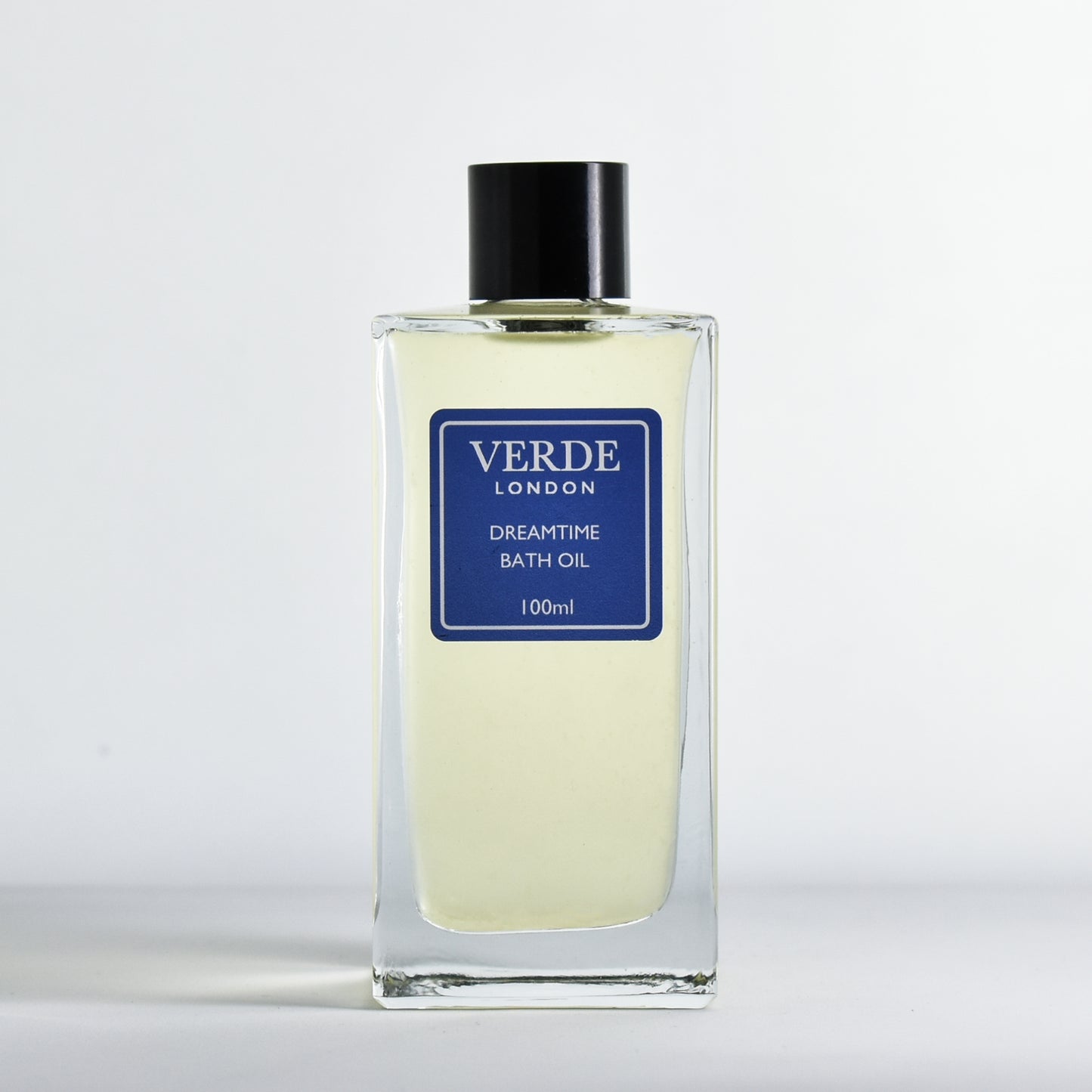 Bottle of Dreamtime Bath oil by Verde London with a dark blue label in a rectangular glass bottle on a white background