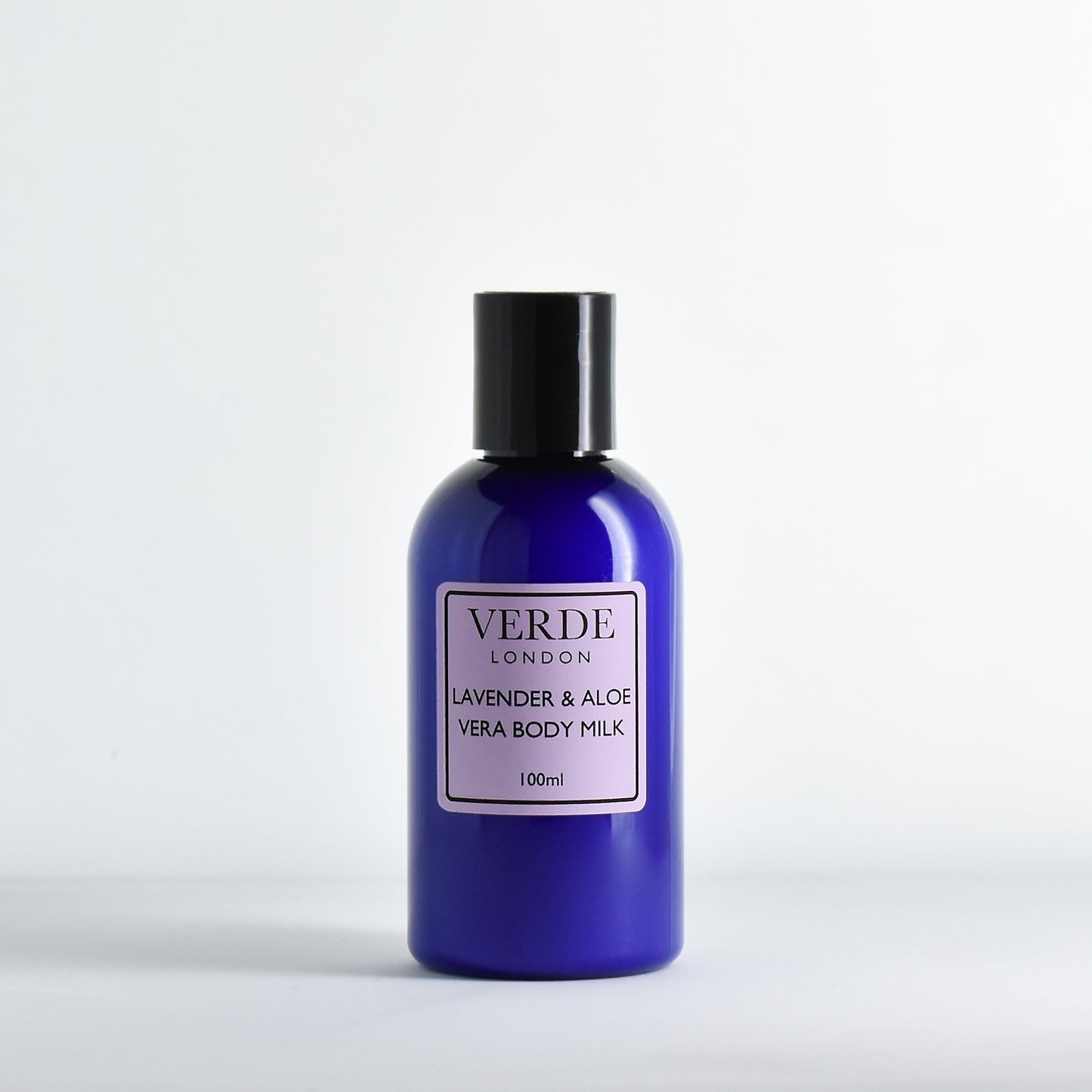 Blue plastic bottle of Verde London Lavender & Aloe Vera Body Milk with a purple label on a white background