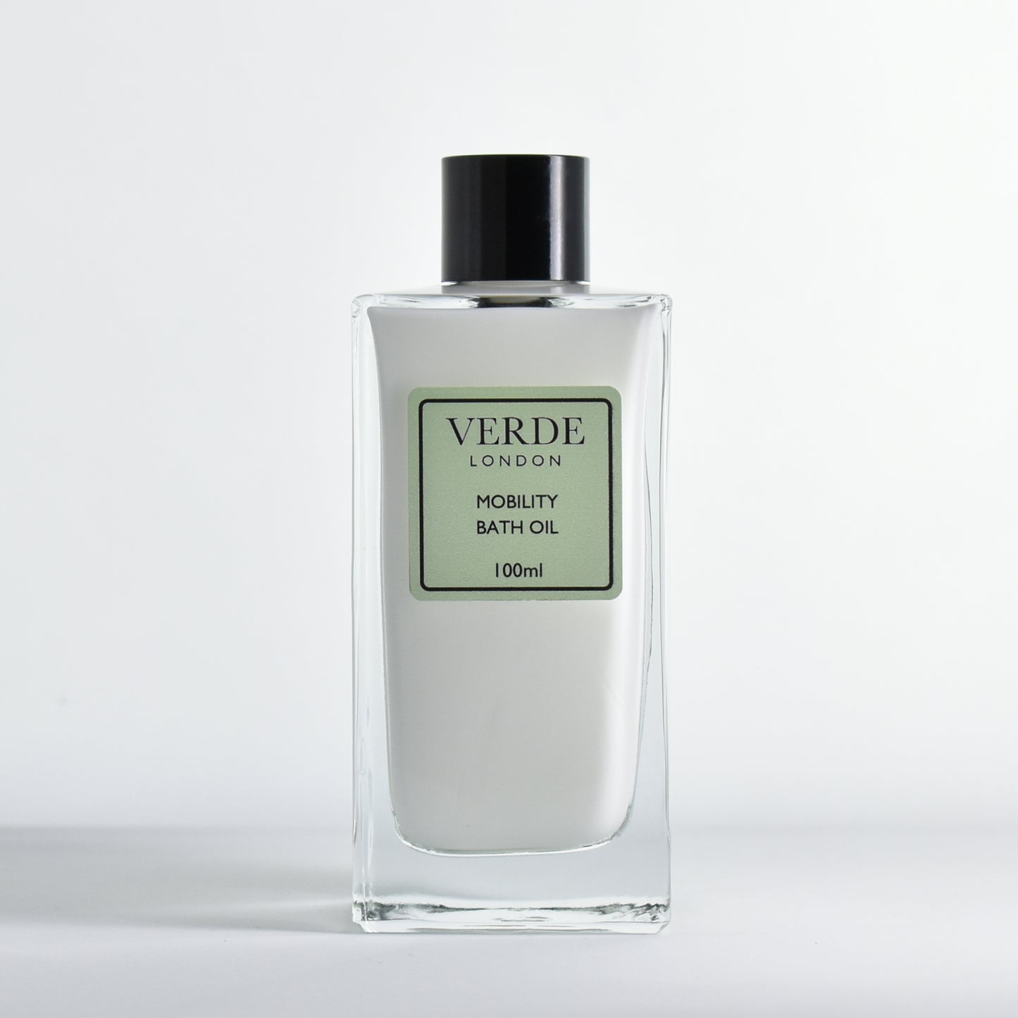 Bottle of 100ml Verde London Mobility Bath Oil, white milky colour in a rectangular glass bottle on a white background