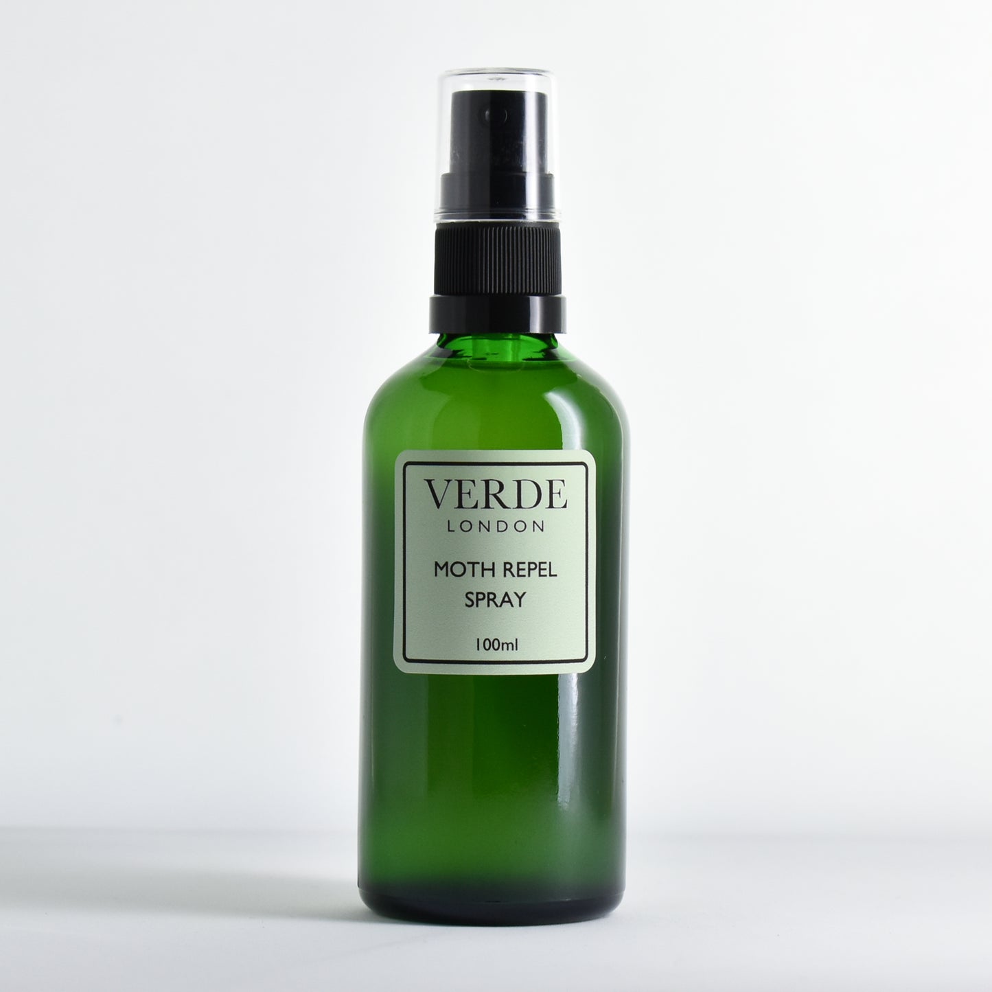 Green bottle of Verde London moth repel spray on a white background