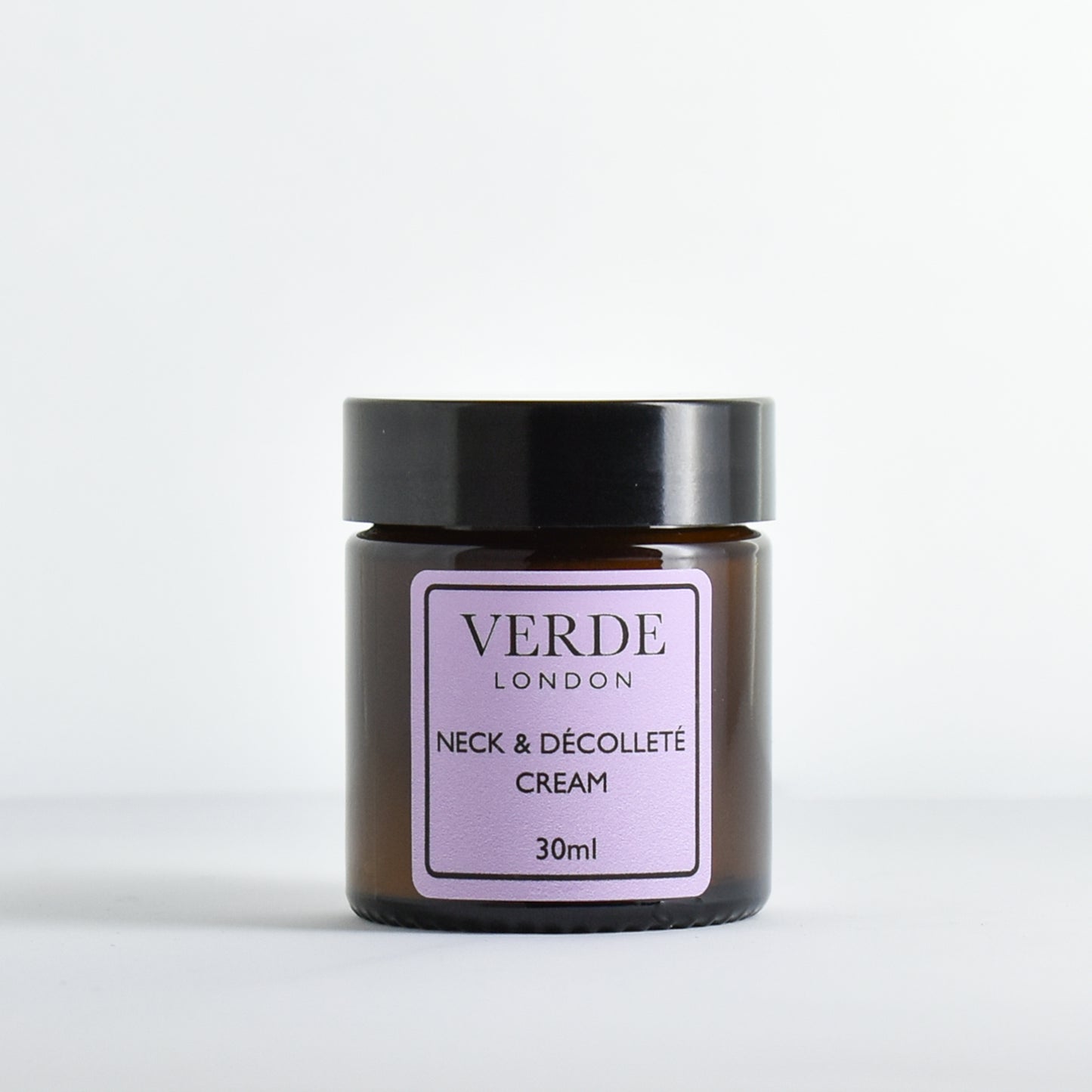 Amber jar of Verde London Neck and Decollete cream with a purple label on a white background