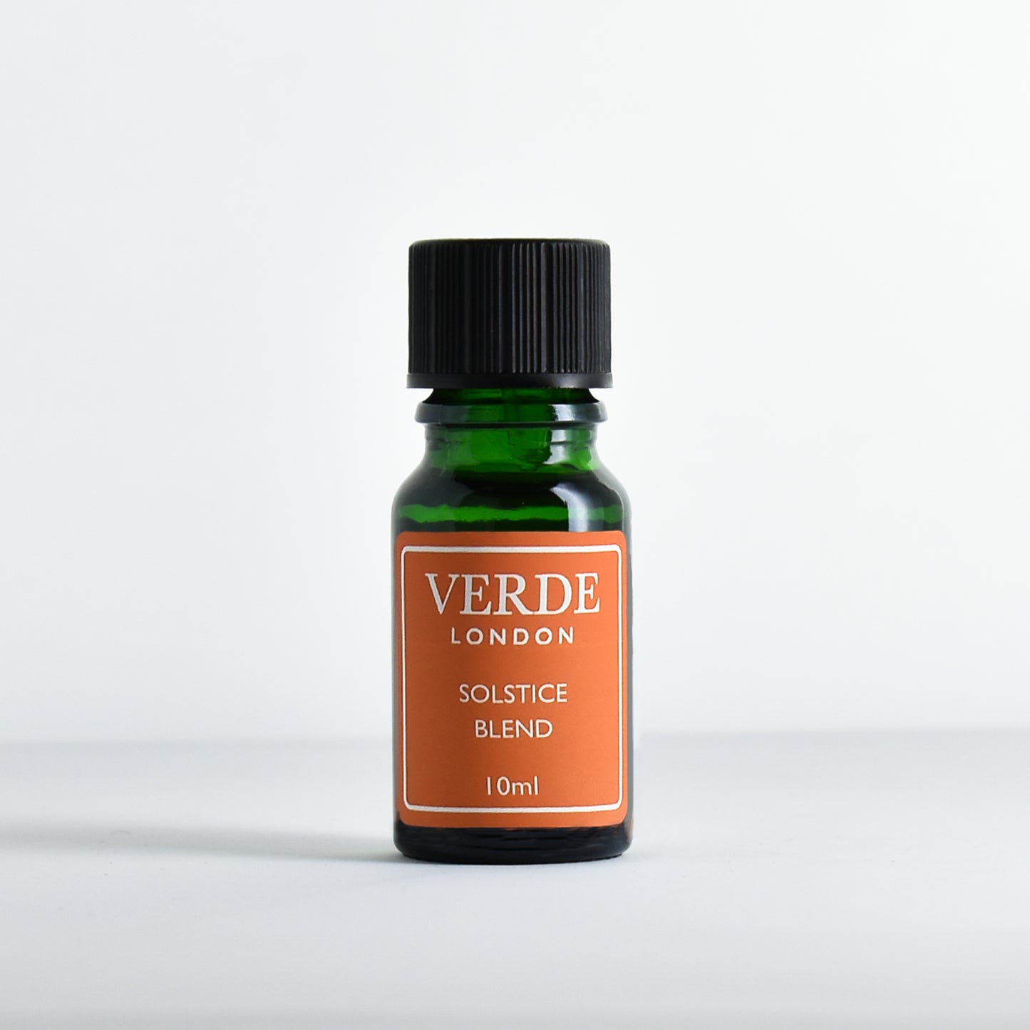 Green bottle of Verde London Solstice Blend with an orange label on a white background
