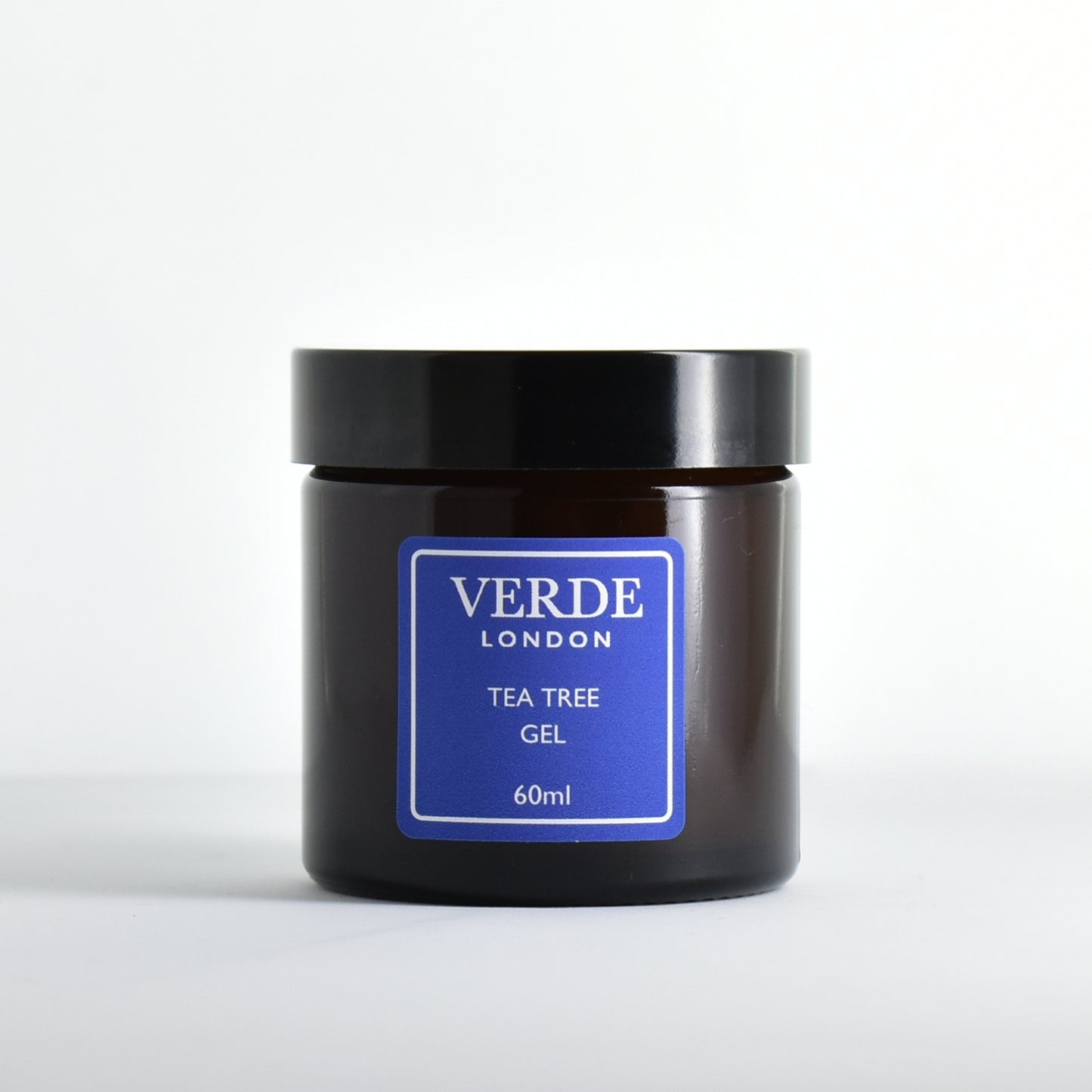 Amber glass jar of Verde London Tea Tree Gel with a blue label on a white background