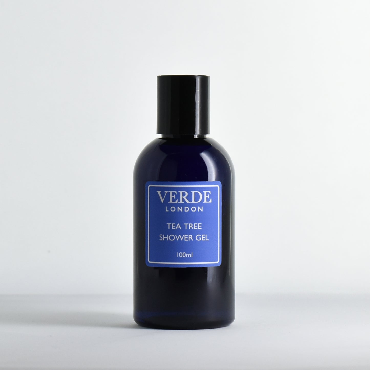 Blue bottle of Verde London Tea Tree Shower Gel with a blue label on a white background