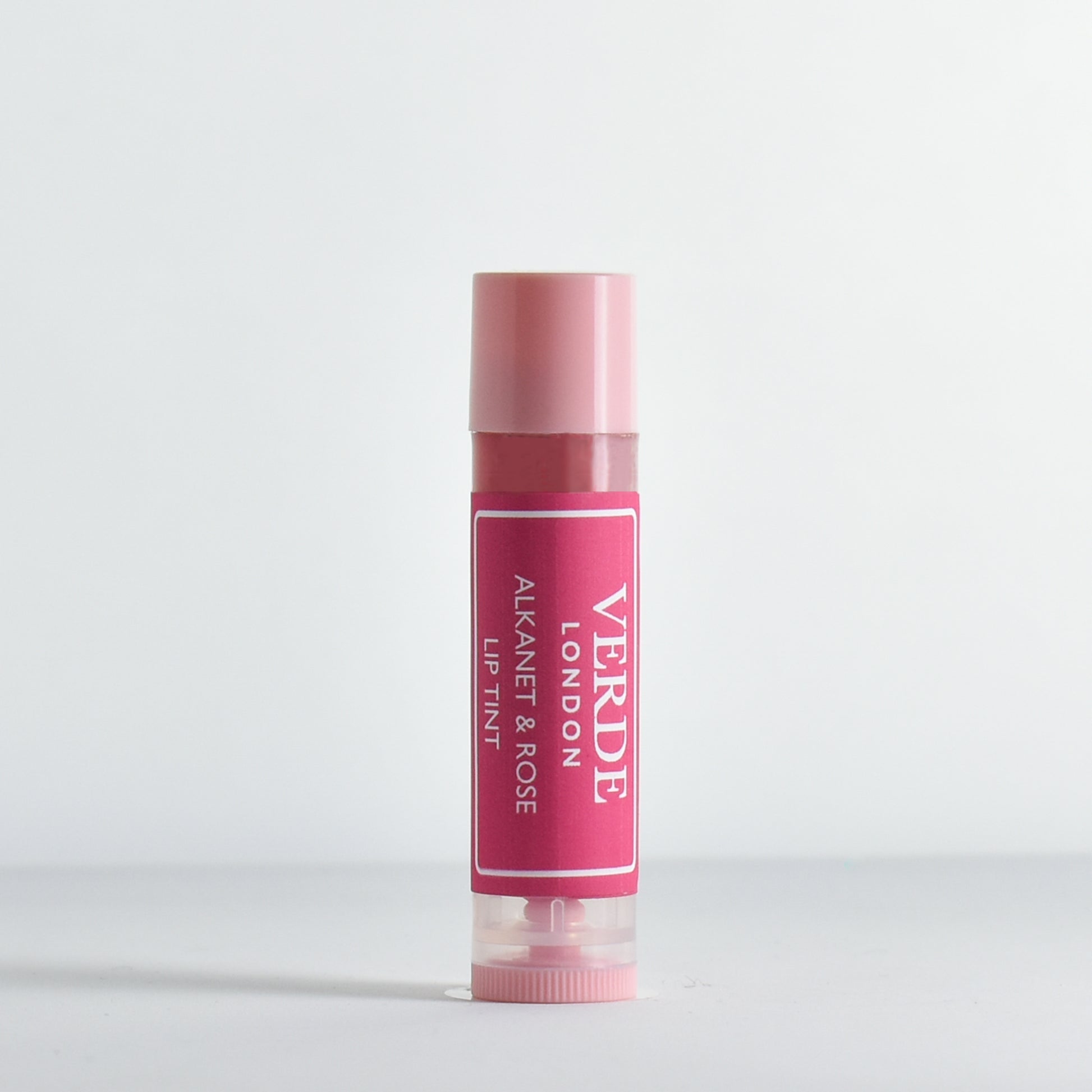 Pink Alkanet and Rose lip tint with visible Verde London brand name on a white background