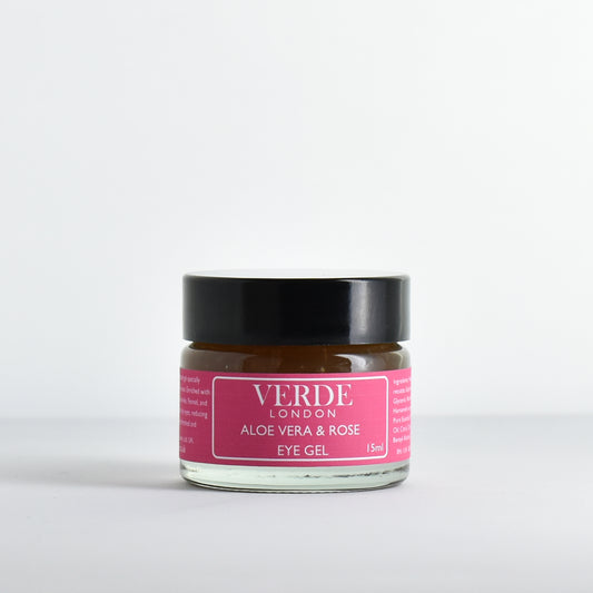 Glass jar of Aloe Vera and Rose Eye Gel with a dark pink label by the brand Verde London on a white background