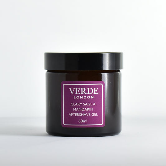 Amber glass jar of Clary Sage and Mandarin Aftershave Gel by the brand Verde London with a purple label on a white background
