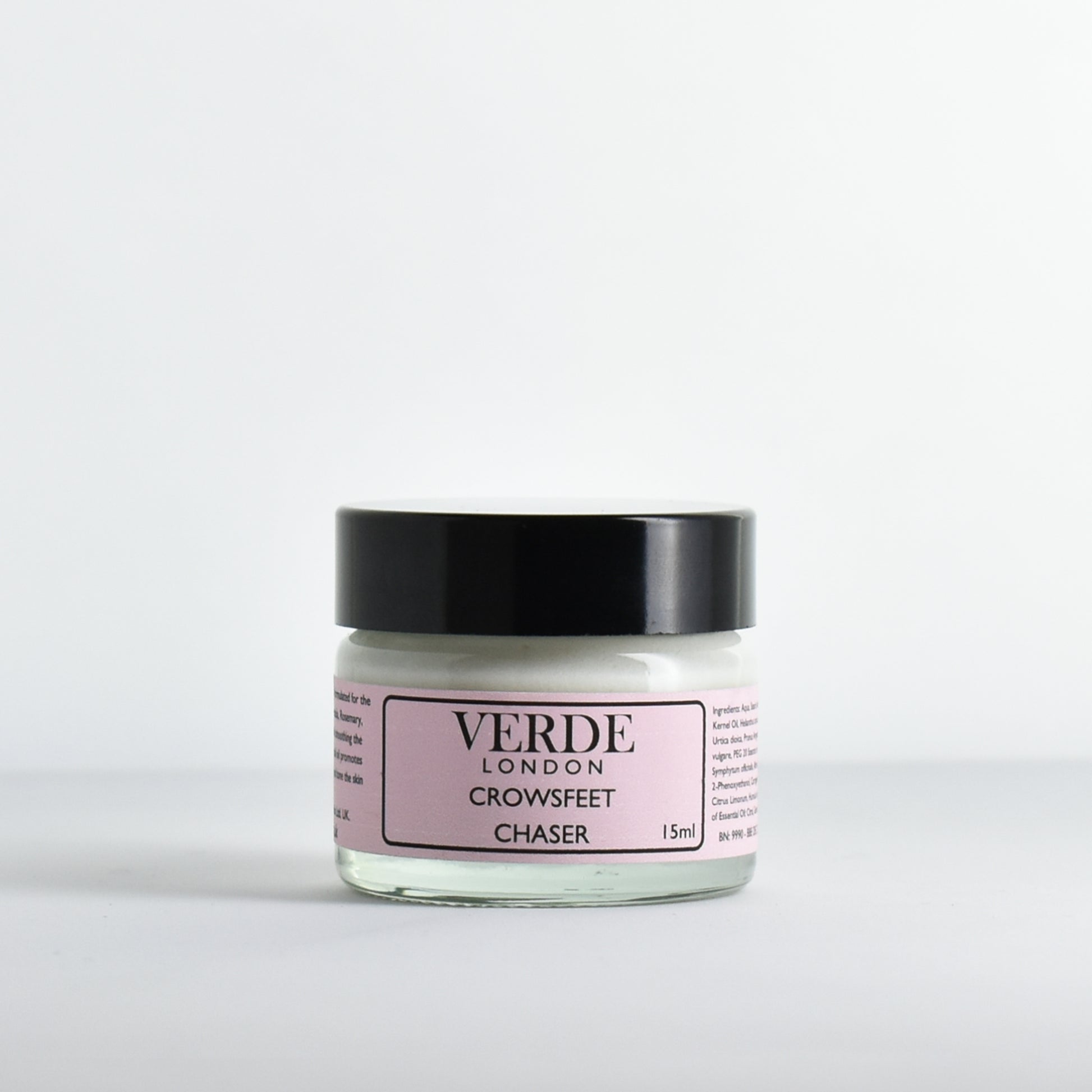 Glass jar of 'Crowsfeet Chaser' by Verde London with a light pink label on a white background