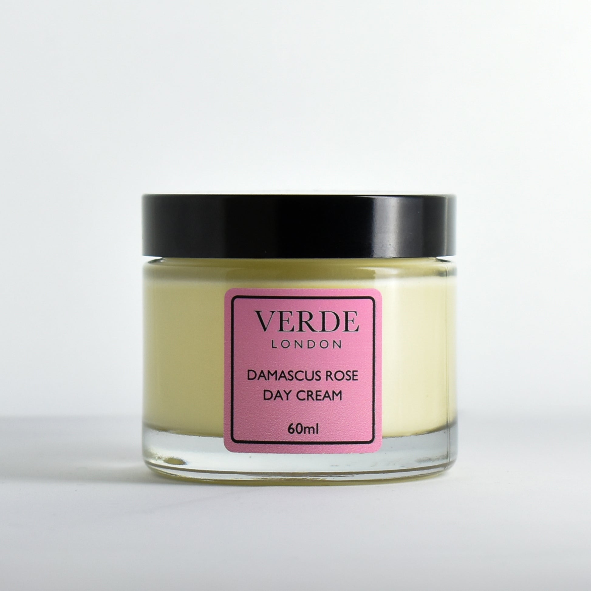 Glass jar of Damascus Rose Day Cream by Verde London with a pink label on a white background