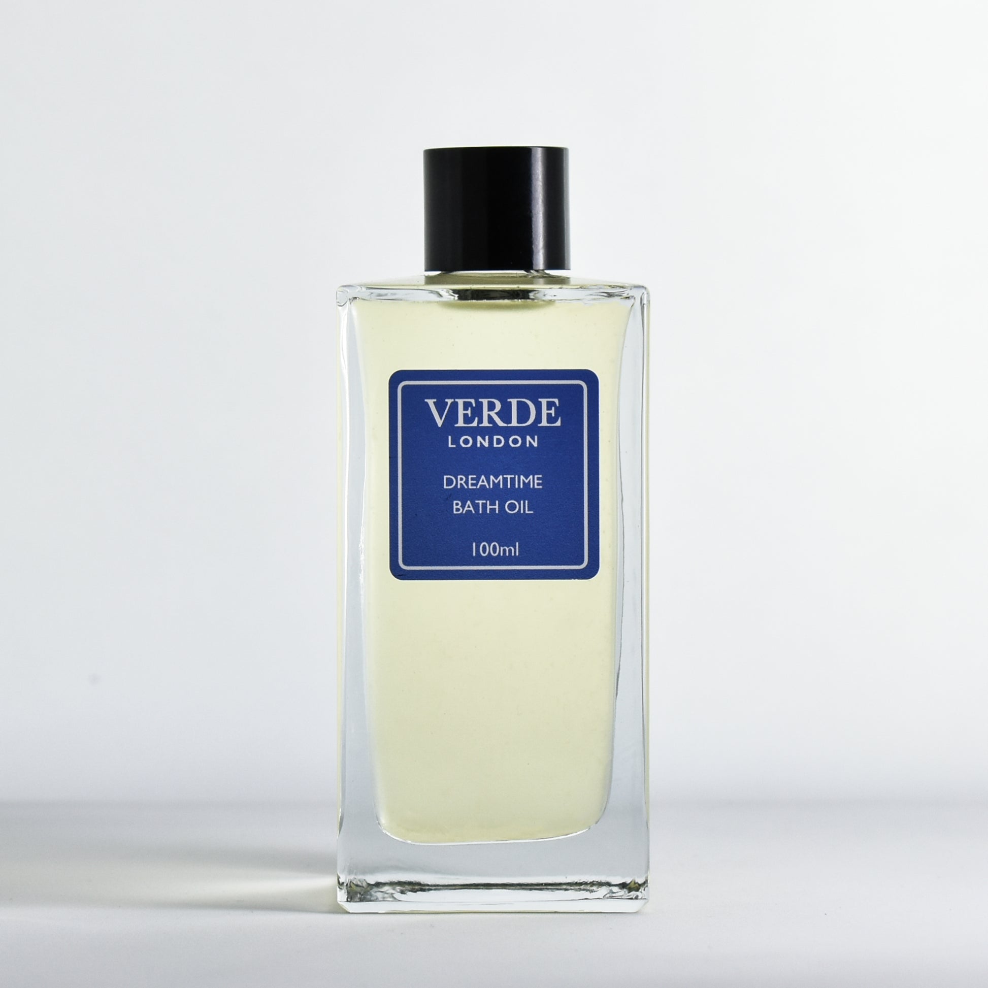 Bottle of Dreamtime Bath oil by Verde London with a dark blue label in a rectangular glass bottle on a white background