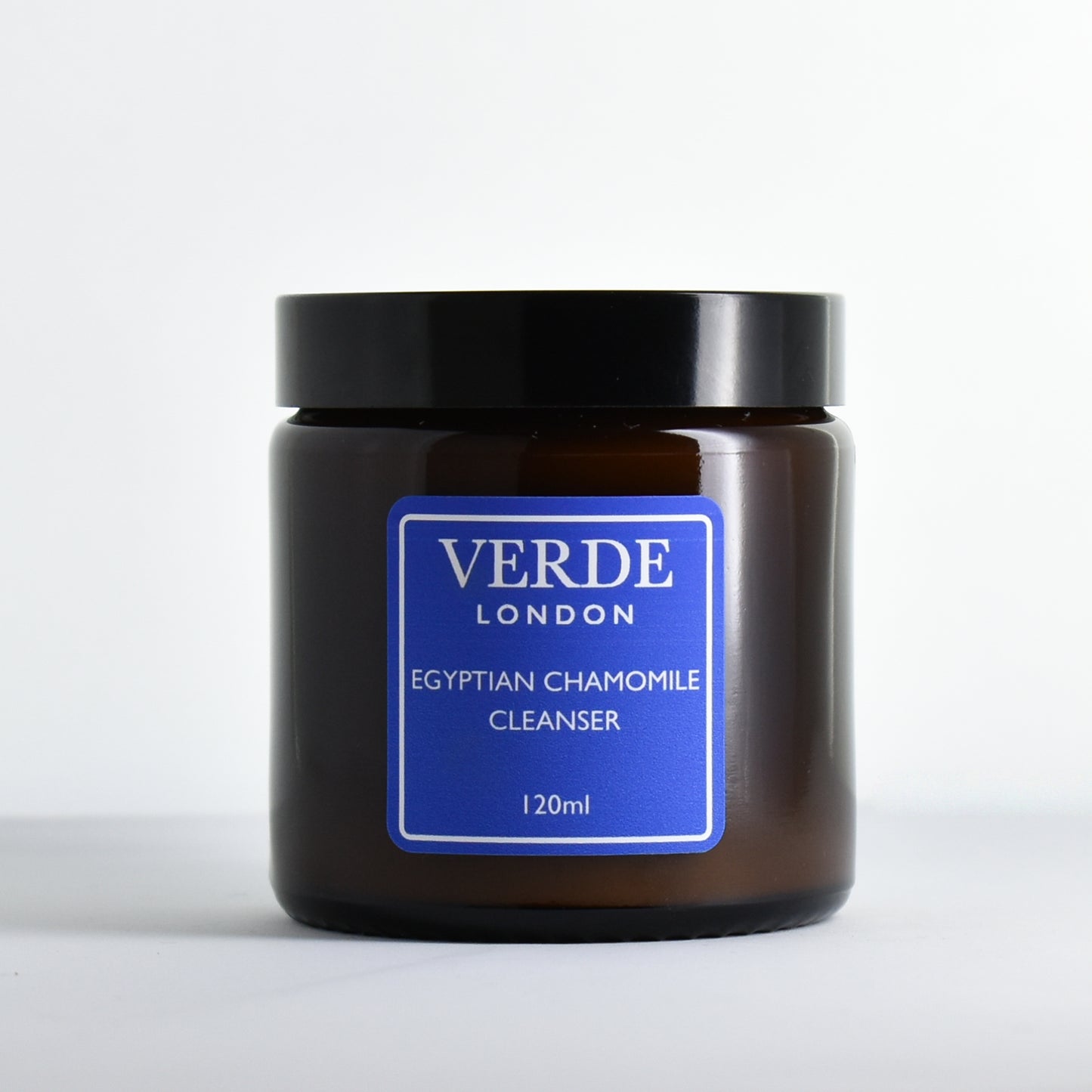 Amber glass jar of Verde London Egyptian Chamomile Cleanser with a blue label on a white background