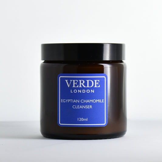 Amber glass jar of Verde London Egyptian Chamomile Cleanser with a blue label on a white background