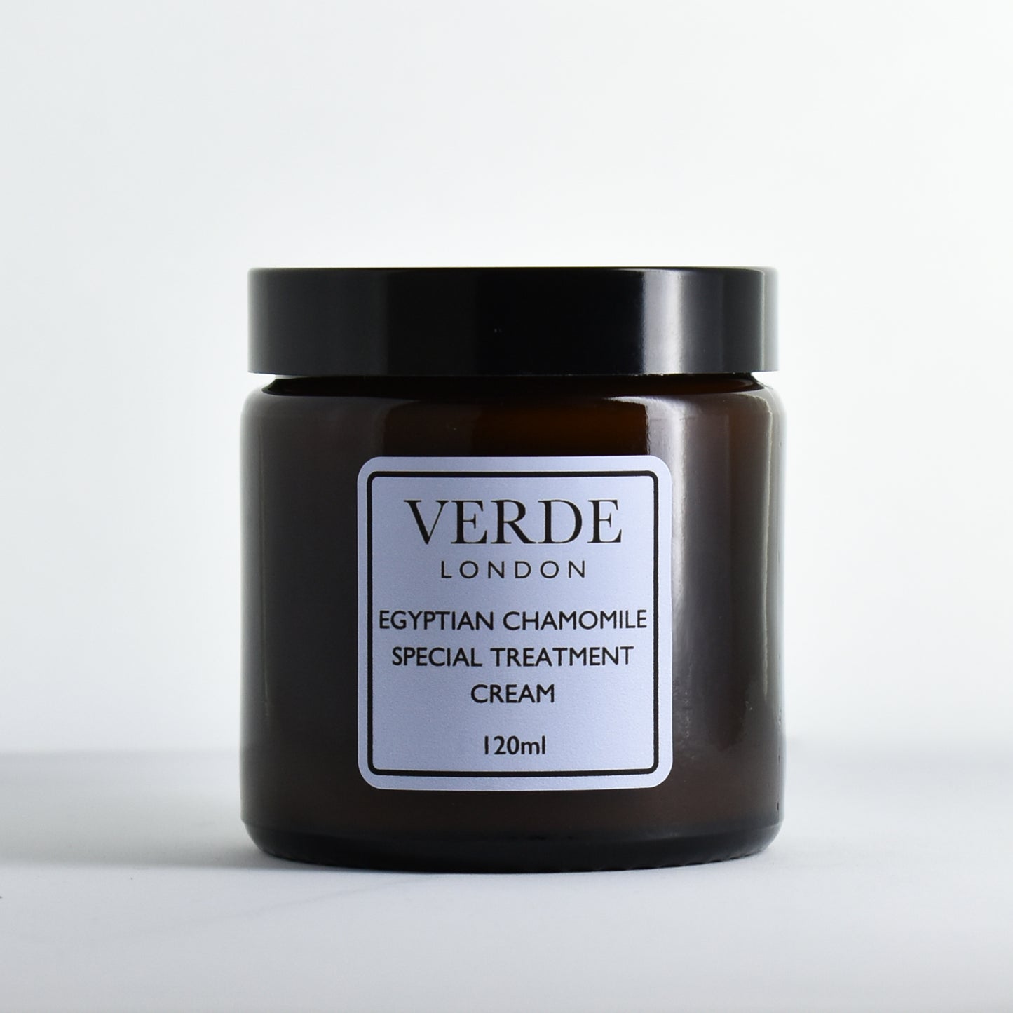 Amber glass jar of Verde London Egyptian Chamomile Special Treatment Cream with a pale blue label on a white background