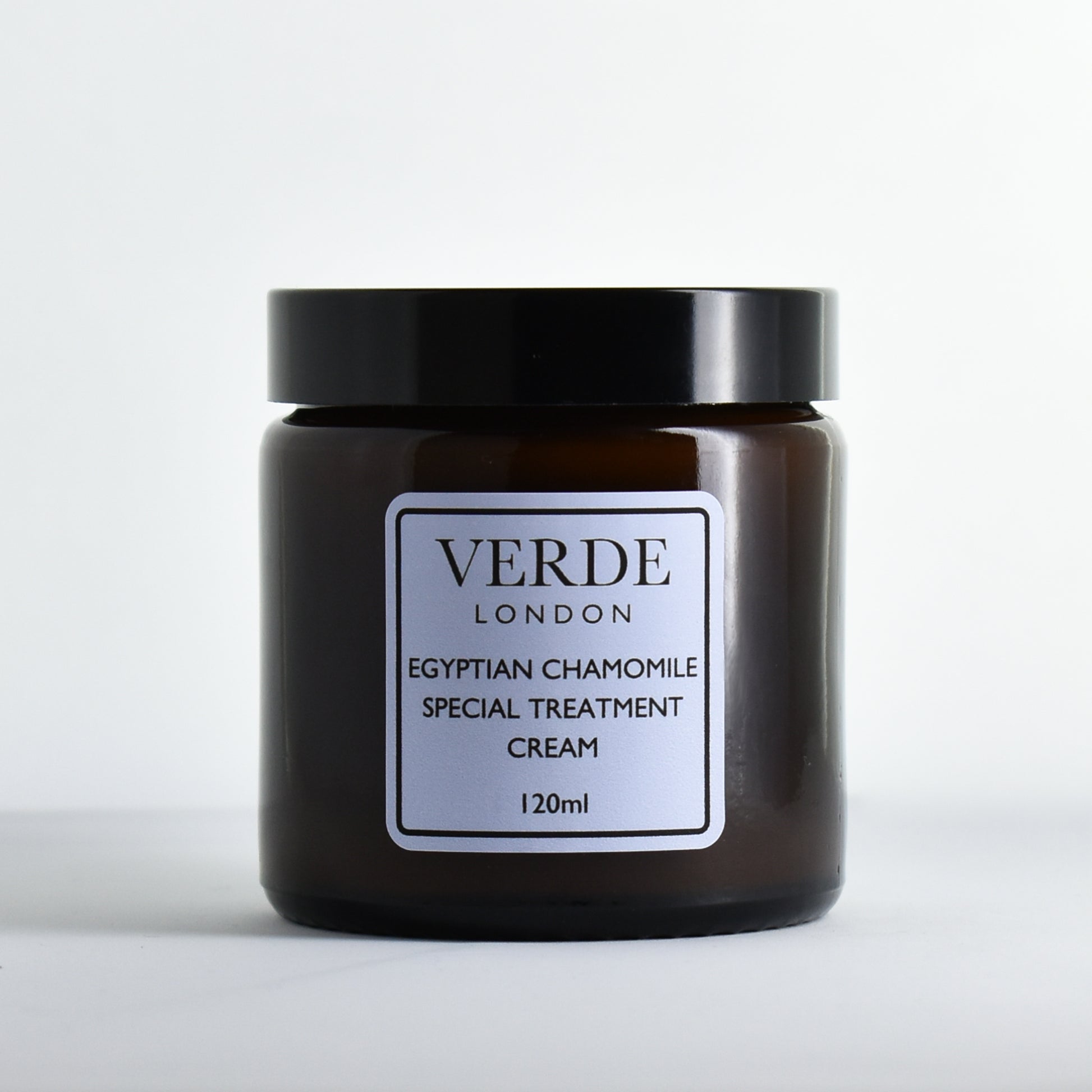 Amber glass jar of Verde London Egyptian Chamomile Special Treatment Cream with a pale blue label on a white background