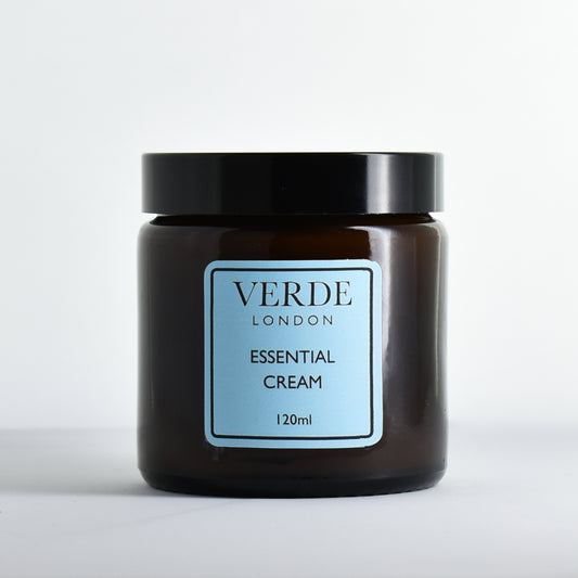 Amber glass jar of Verde London Essential Cream with a blue label on a white background