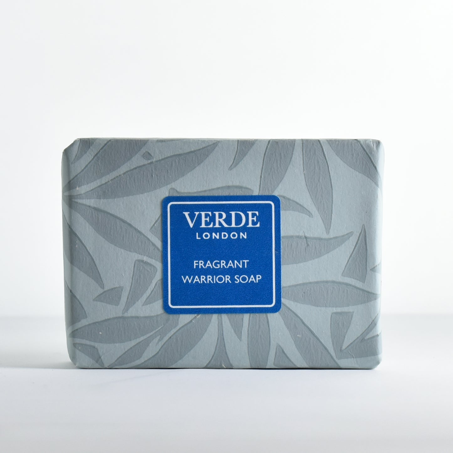 Bar of soap 'Fragrant Warrior Soap' wrapped in patterned paper with a turquoise label from the brand Verde London.