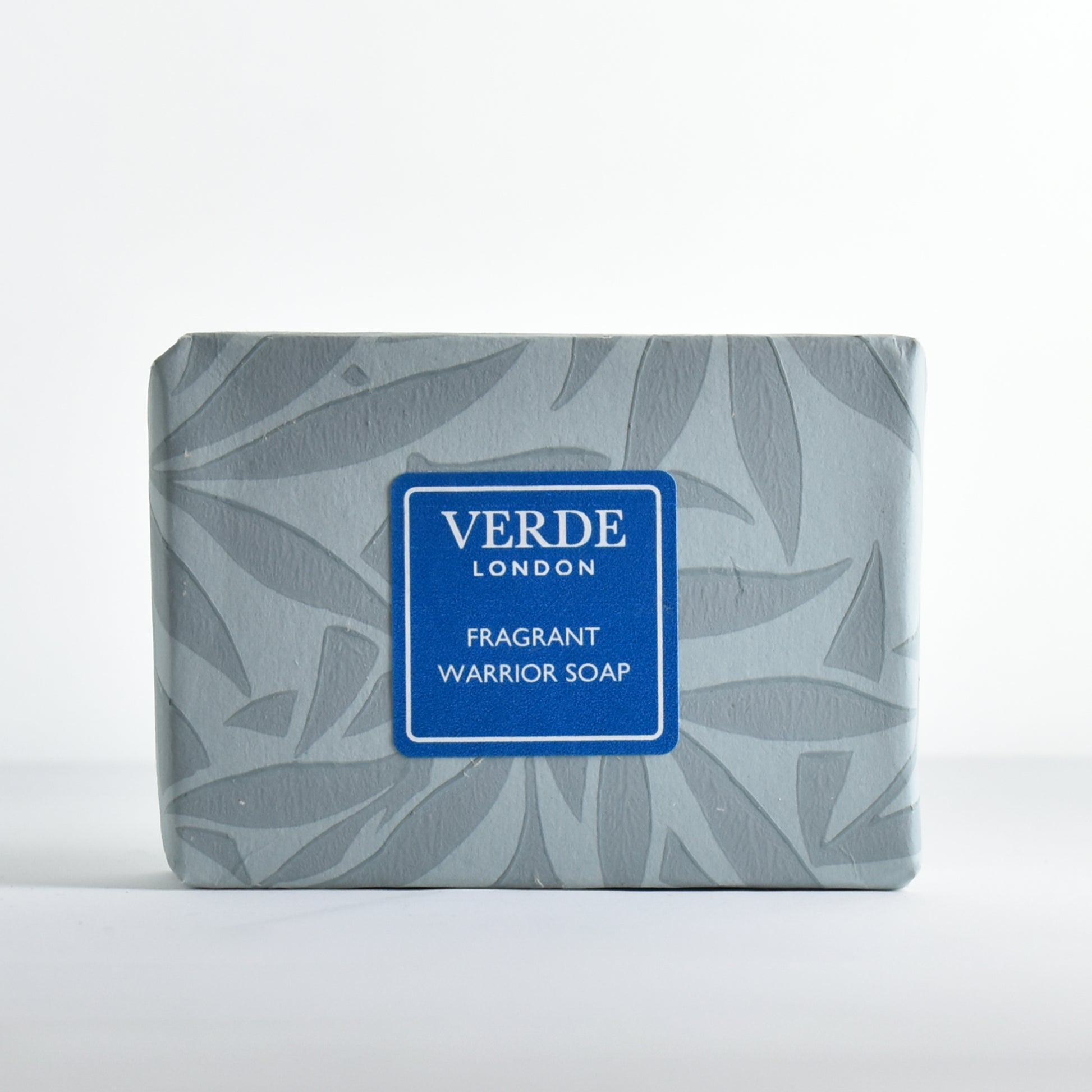 Bar of soap 'Fragrant Warrior Soap' wrapped in patterned paper with a turquoise label from the brand Verde London.
