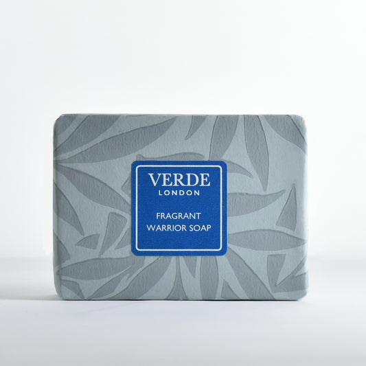 Bar of soap 'Fragrant Warrior Soap' wrapped in patterned paper with a turquoise label from the brand Verde London on a white background