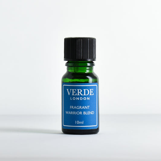 Green glass dropper bottle with turquoise label containing 'Fragrant Warrior Blend' by Verde London on a white background.