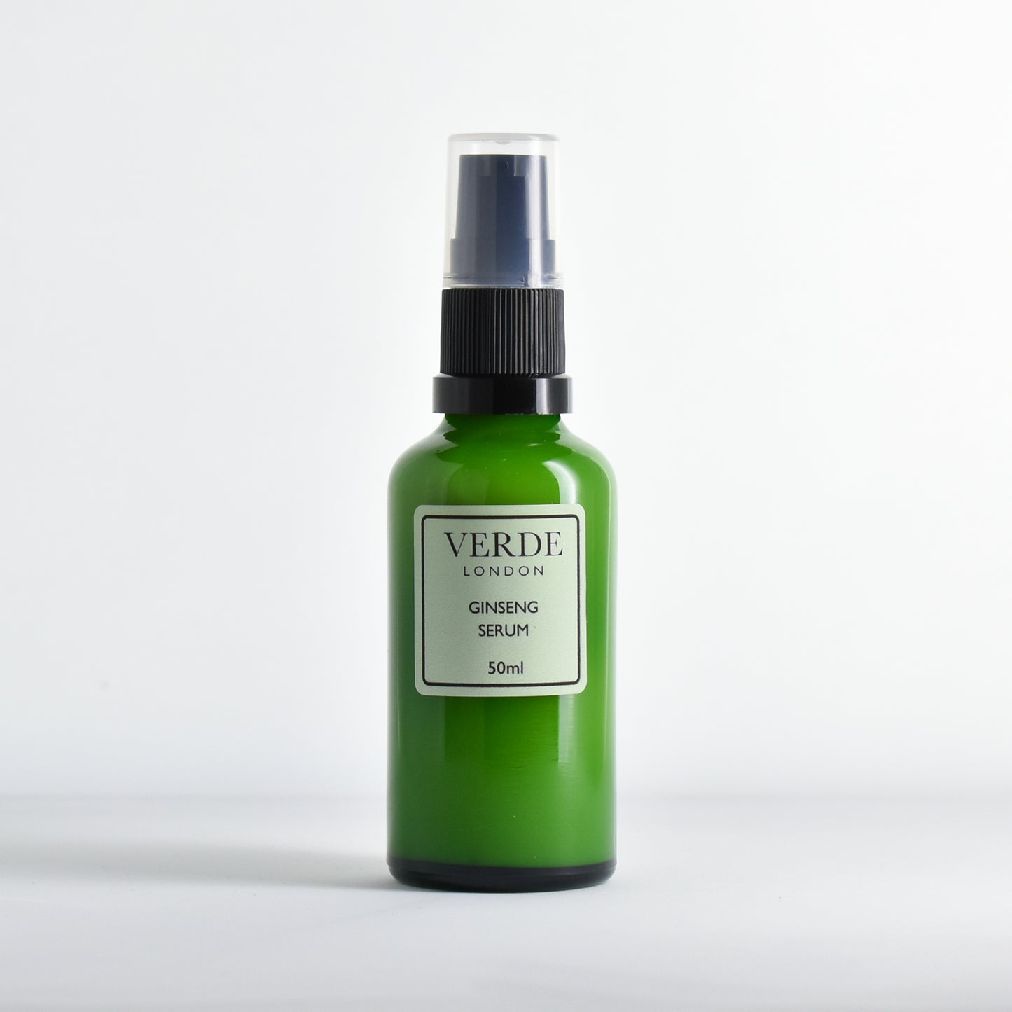 Green Ginseng serum bottle by the brand Verde London with black pump nozzle with a green label on a white background