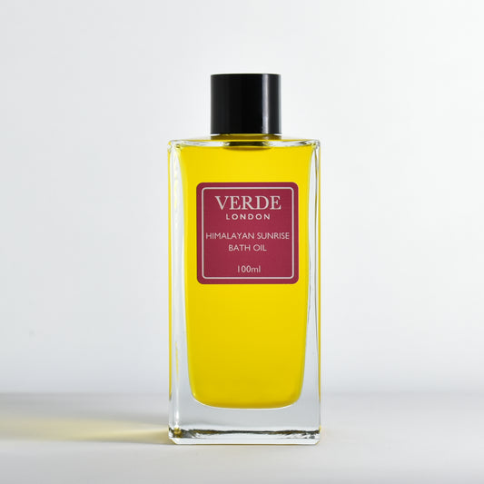 Bottle of Verde London Himalayan Sunrise Bath Oil 100ml with a pink label in a rectangular glass bottle on a white background
