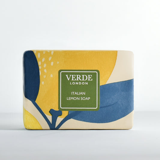Bar of soap with a decorative yellow, blue, and beige packaging featuring lemons with a green label and the brand 'Verde London' on a white background
