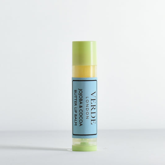 Jojoba and Cocoa Butter Lip balm with green cap and blue label by the brand Verde London on a white background