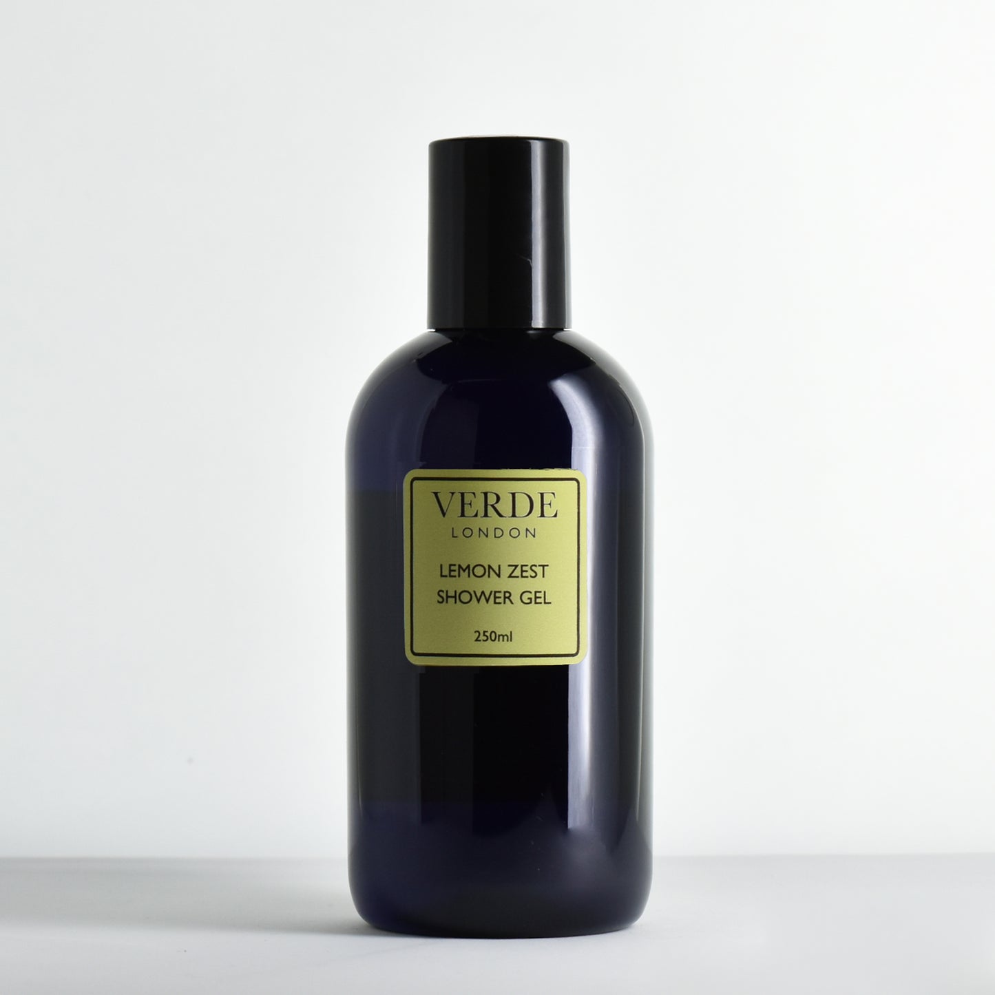 Blue bottle of Verde London Lemon Zest Shower Gel with a pale green label on a white background
