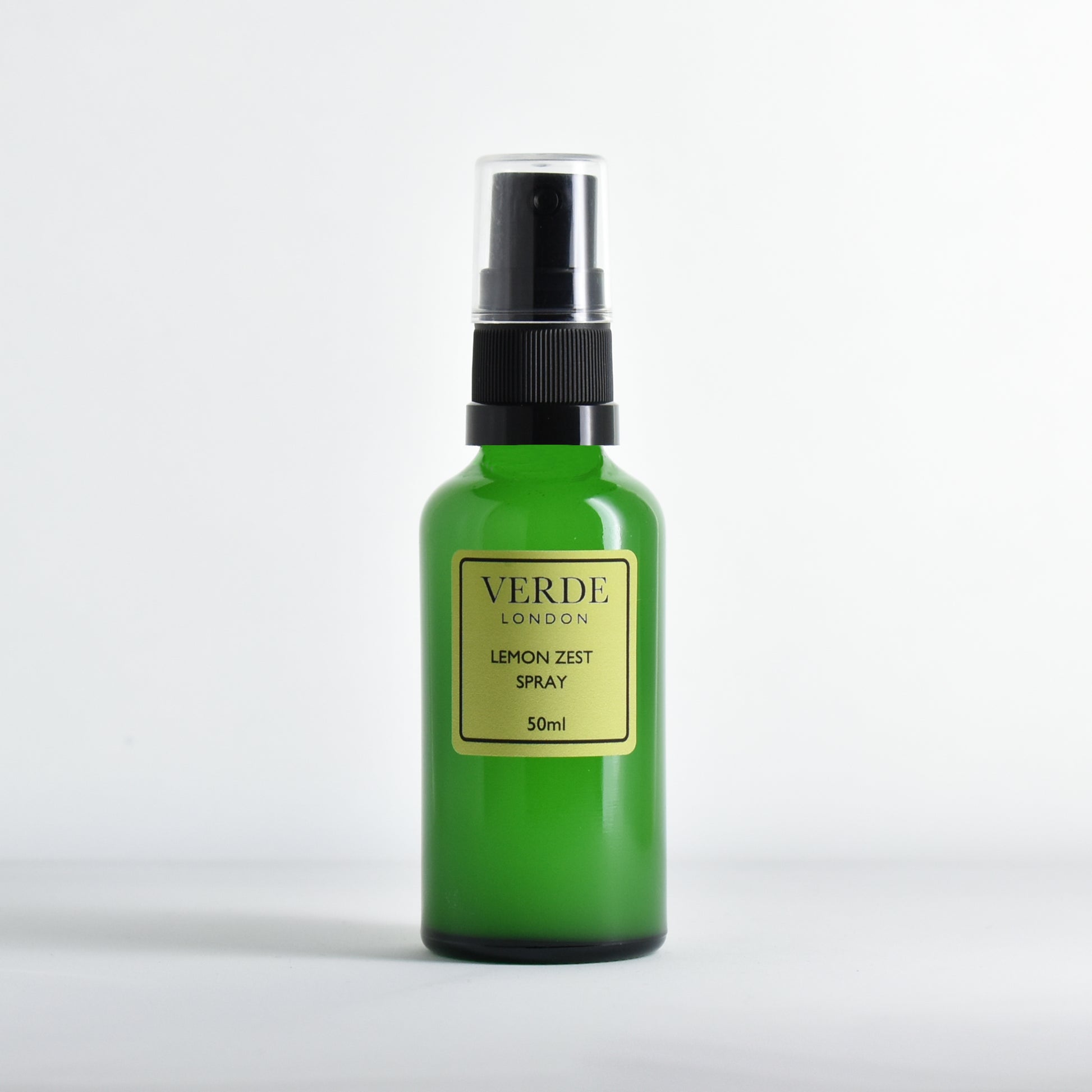 Green glass spray bottle of Verde London Lemon Zest spray with a pale green label on a white background