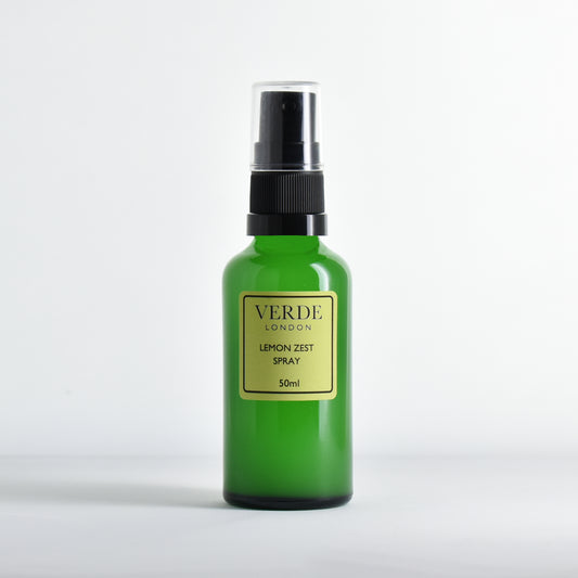 Green glass spray bottle of Verde London Lemon Zest spray with a pale green label on a white background