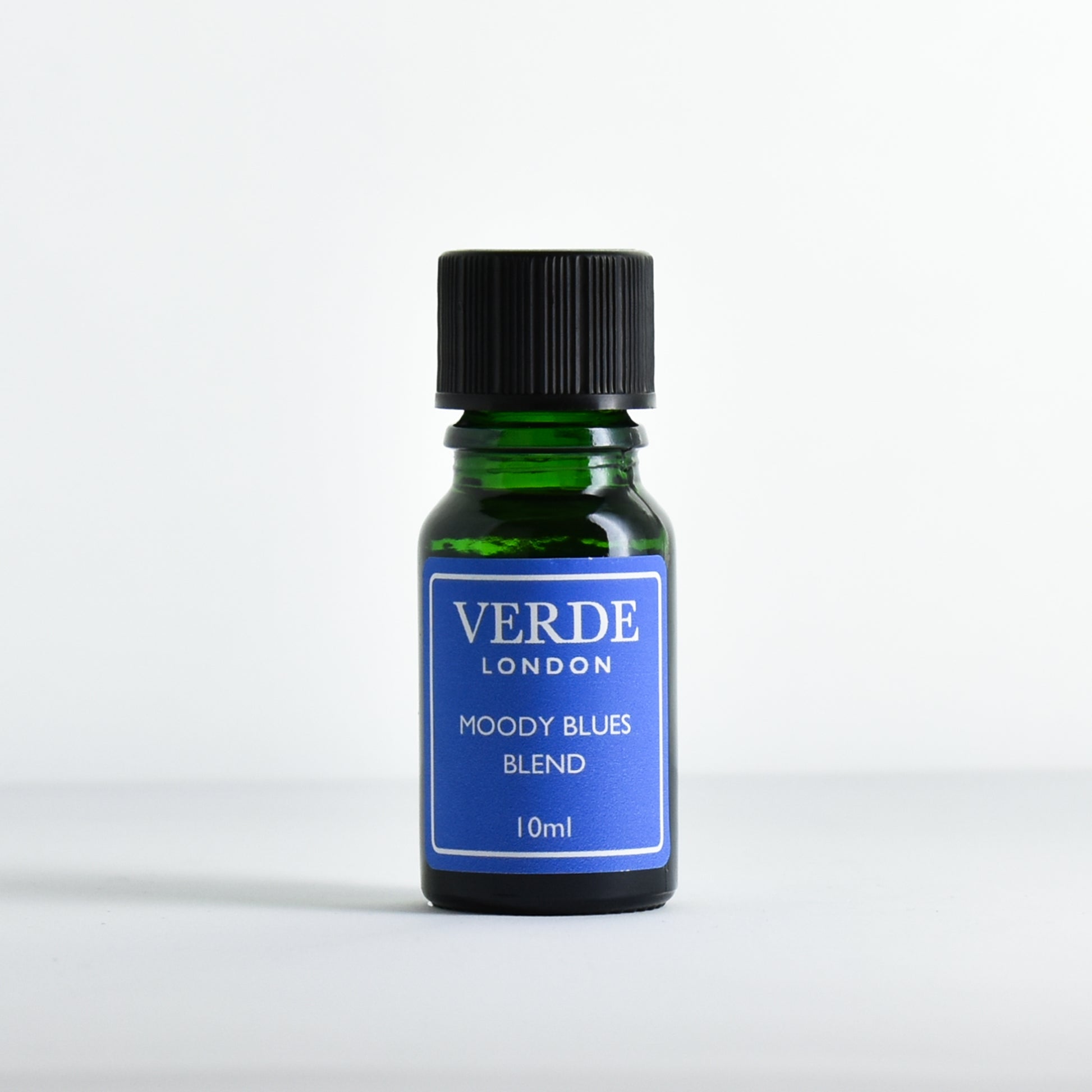 Green glass dropper bottle with a blue label containing 'Moody Blues Blend' by Verde London on a white background.