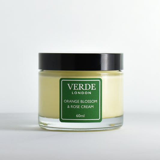 Glass jar of Orange Blossom and Rose cream with a green label by the brand Verde London on a white background