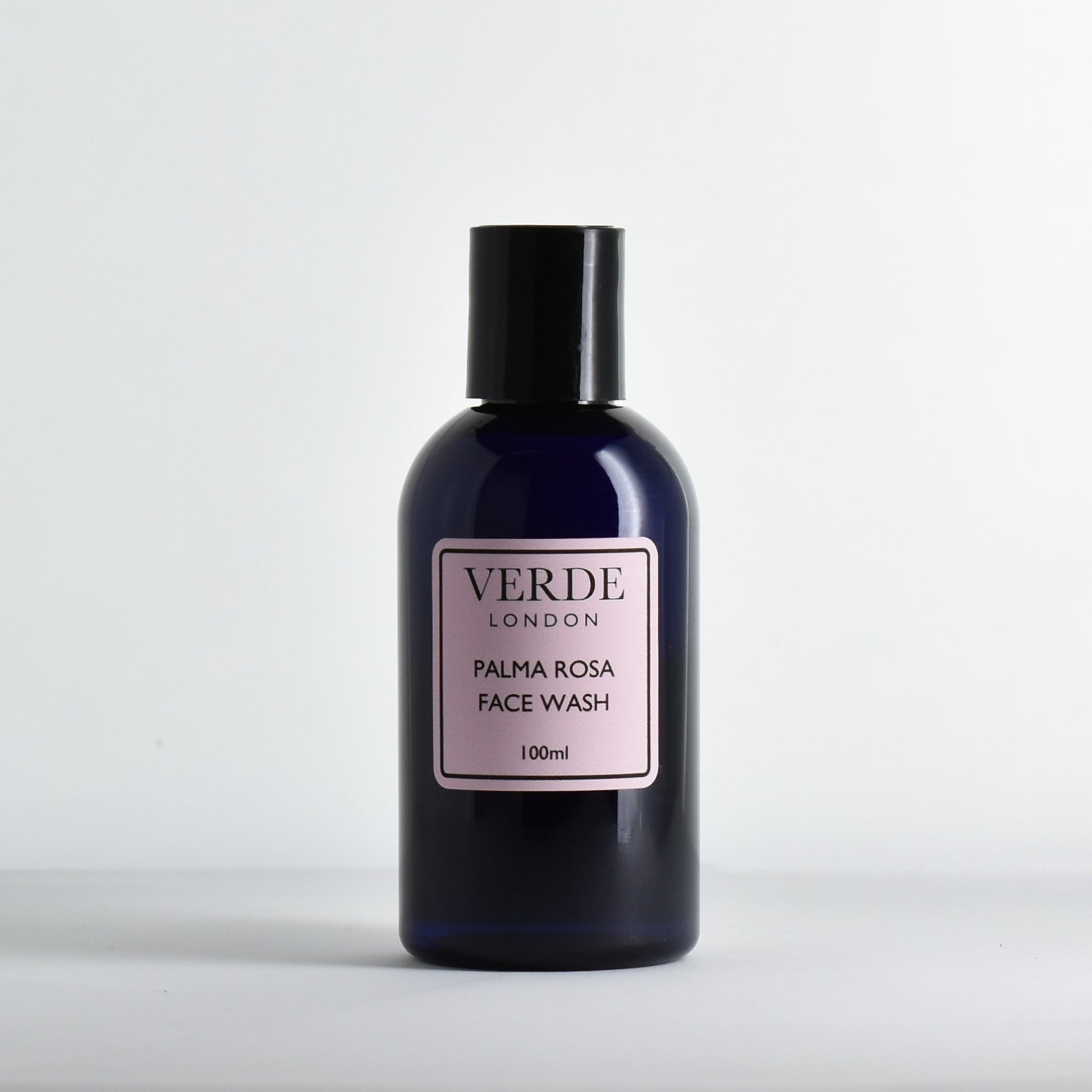 Blue bottle of Palma Rosa Face Wash by Verde London with a pink label on a white background