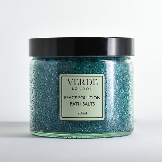 Glass jar of Verde London green Peace Solution Bath Salts on a white background