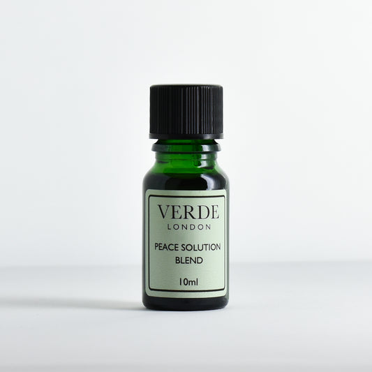 Green glass dropper bottle with pale green label containing 'Peace Solution Blend' by Verde London on a white background.