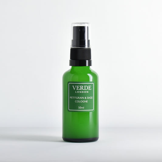 Green glass bottle of Verde London Pteigrain and Sage cologne with a green label on a white background