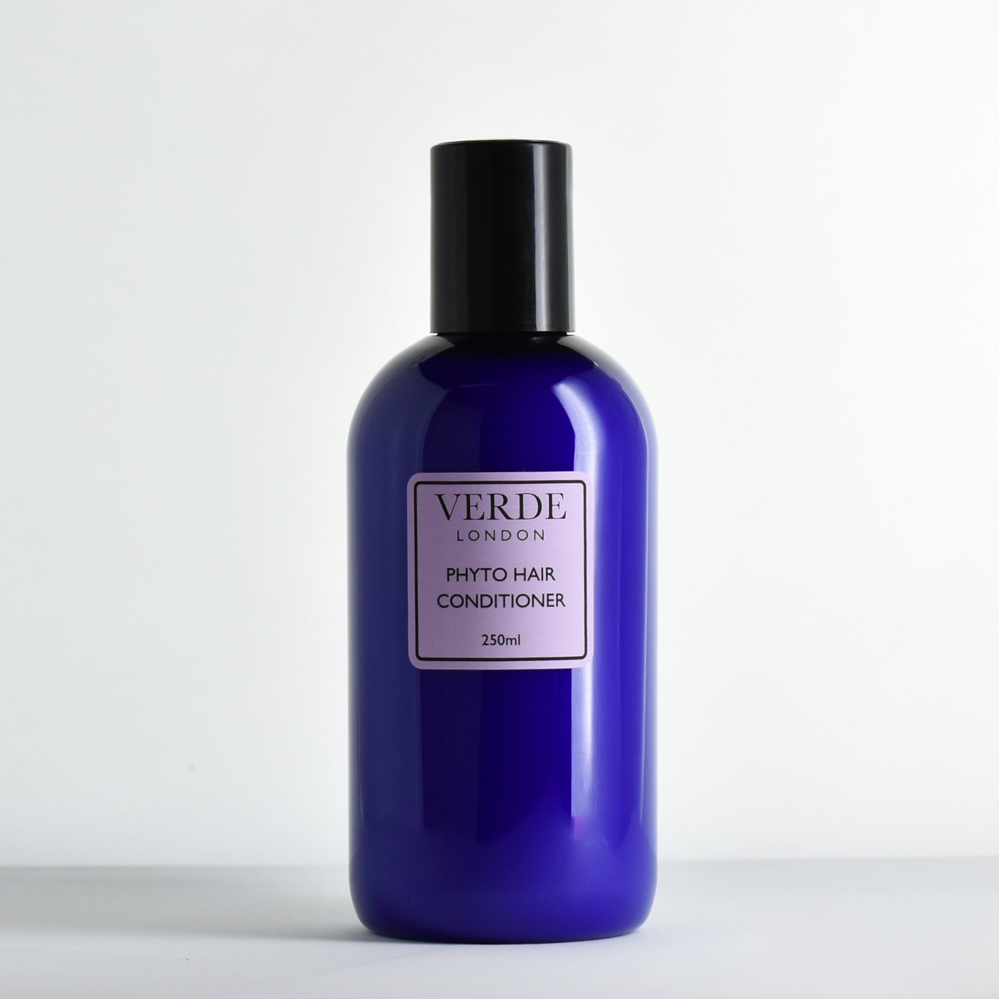 Blue bottle of Verde London Phyto Hair Conditioner with a purple label on a white background