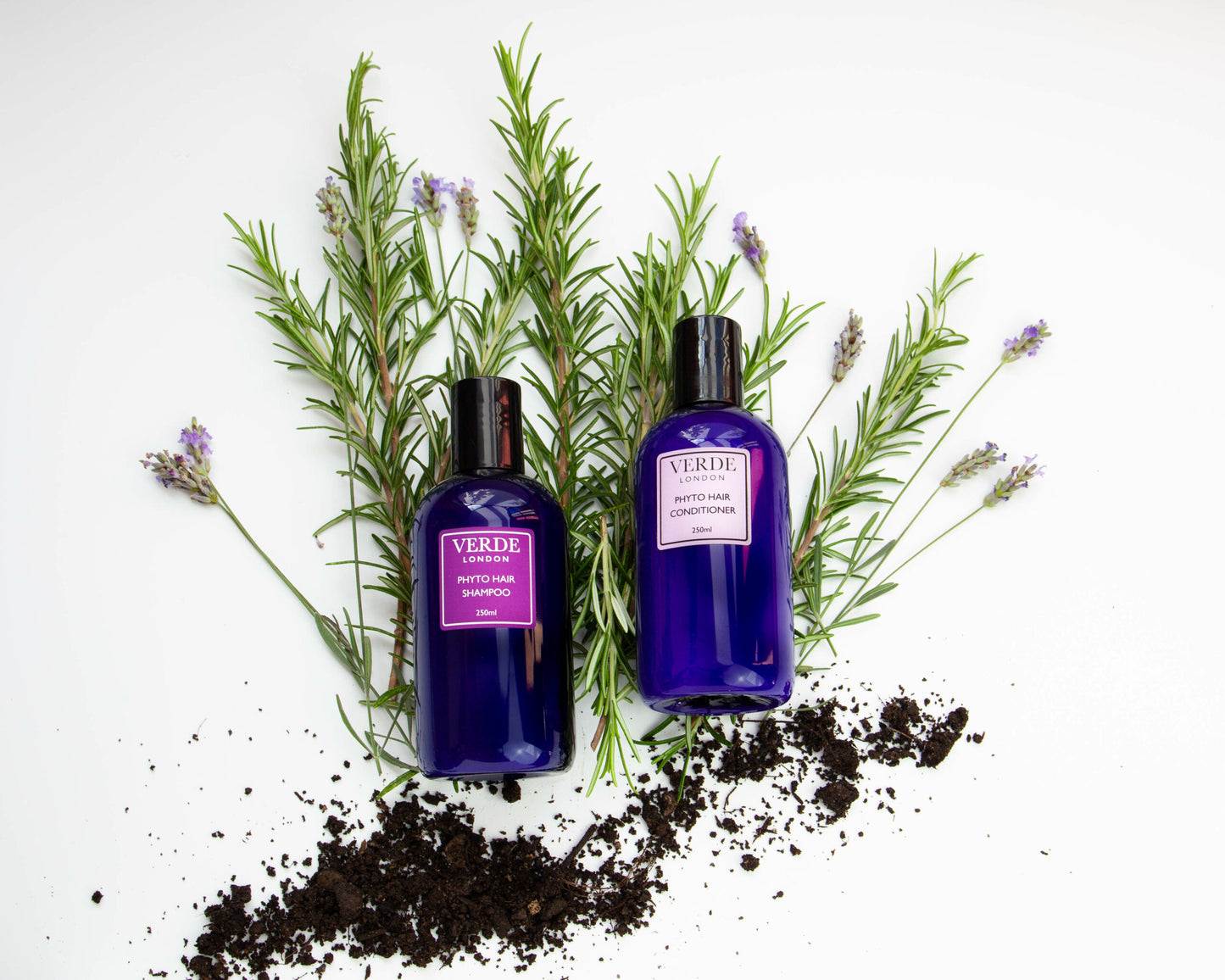 Two bottles of Vero branded hair care products, one shampoo and one conditioner, with a sprig of lavender in the Background on a white background