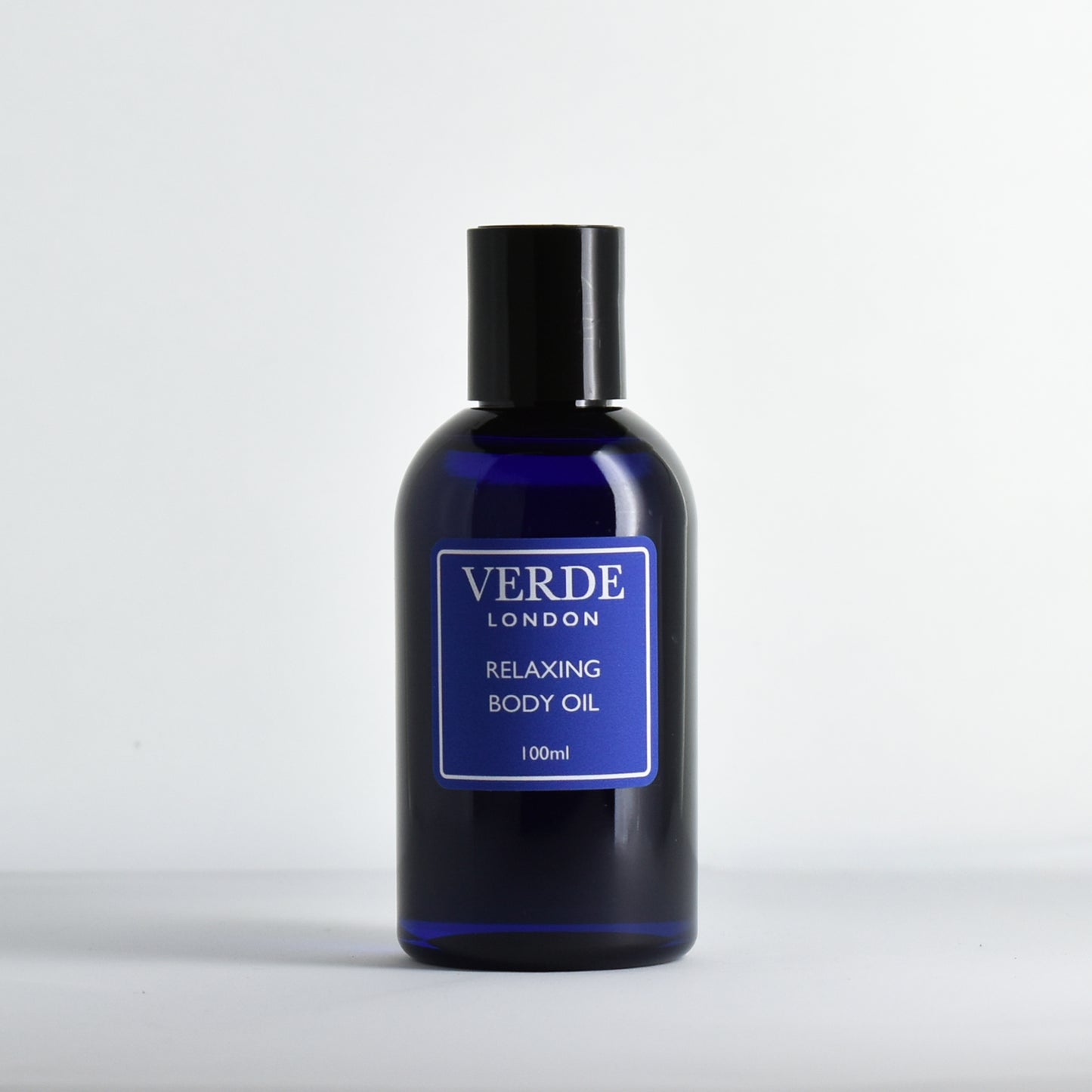 Blue 100ml bottle of Relaxing Body oil by the brand Verde London with a blue label on a white background