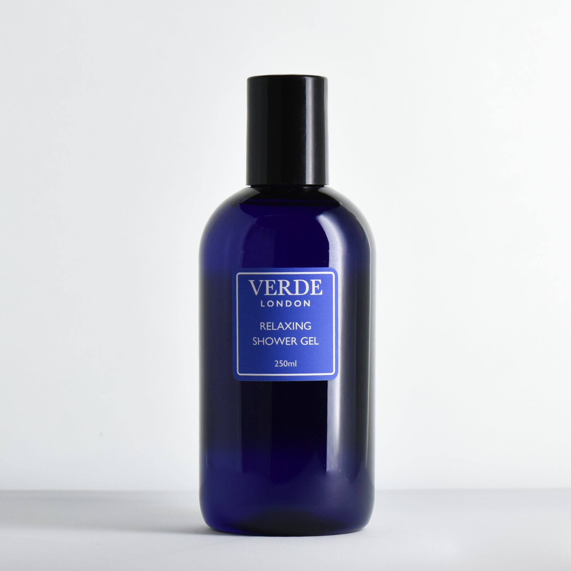 Blue bottle of Verde London 'Relaxing shower gel' with a blue label on a white background