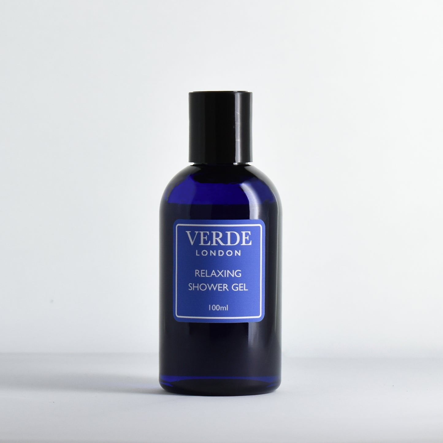 Blue bottle of Verde London 'Relaxing shower gel' with a blue label on a white background