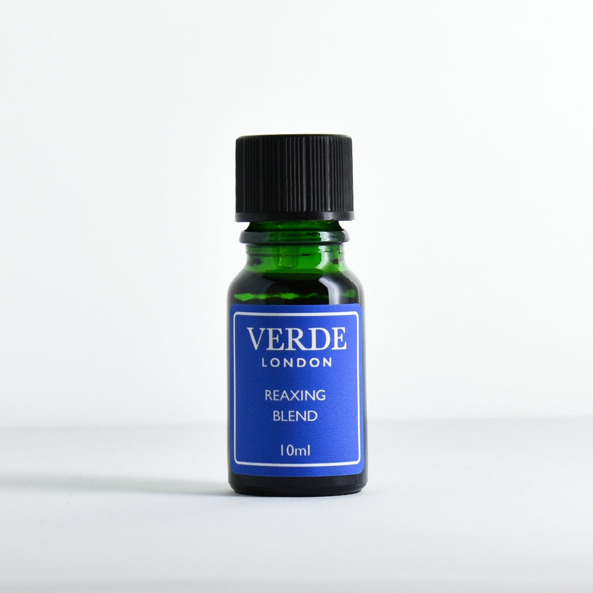 Green glass dropper bottle with blue label containing 'Relaxing Blend' by Verde London on a white background.