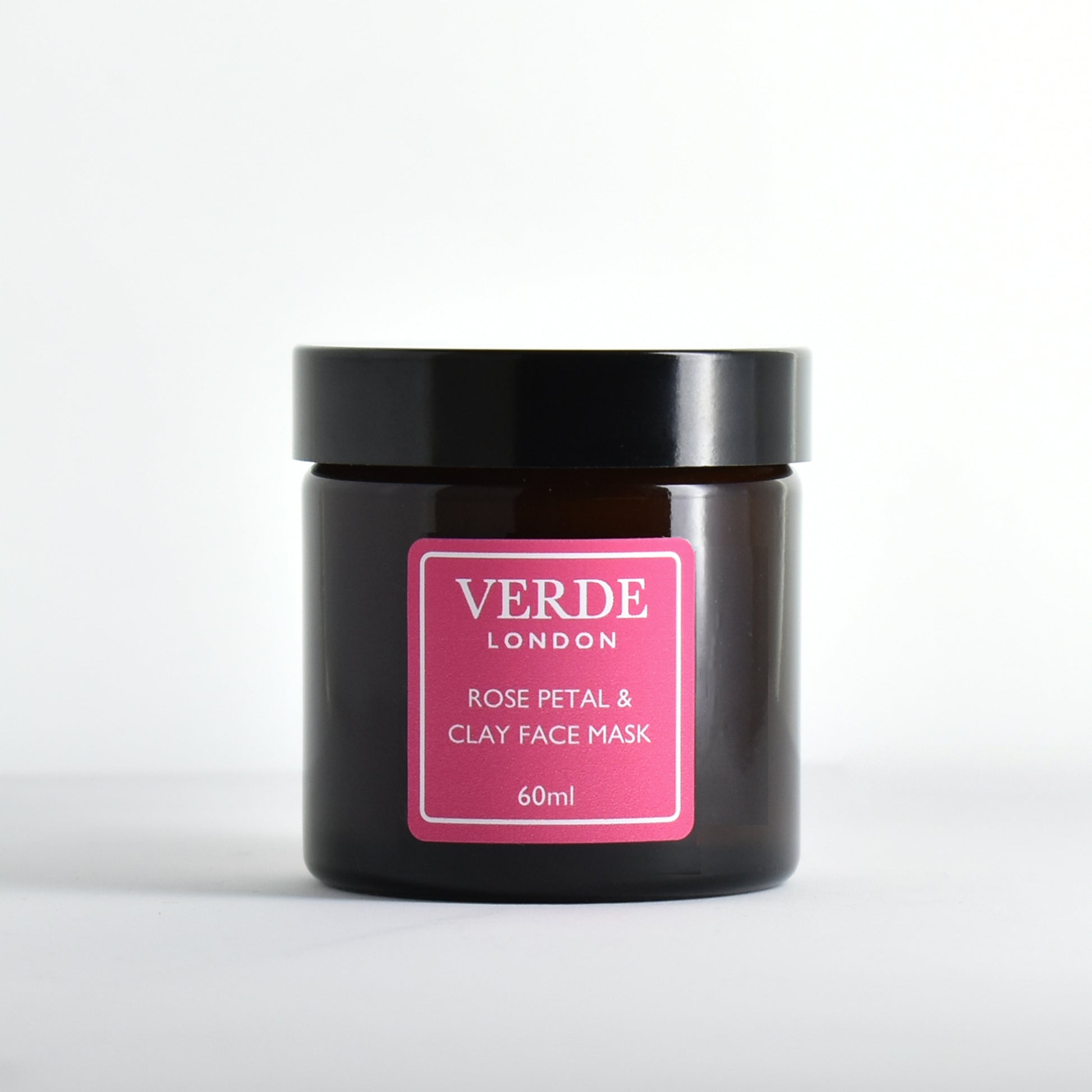 Amber glass jar of Verde London rose petal and clay face mask with a pink label on a white background