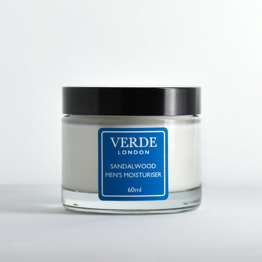 Glass jar of sandalwood men's moisturiser with a blue label by the brand Verde London on a white background