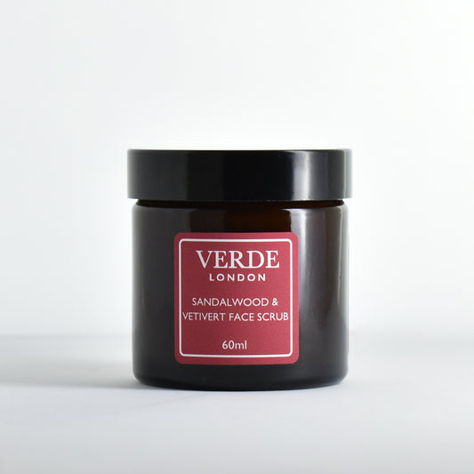 Amber glass jar of Verde London Sandalwood & Vetiver Face Scrub with a red label on a white background