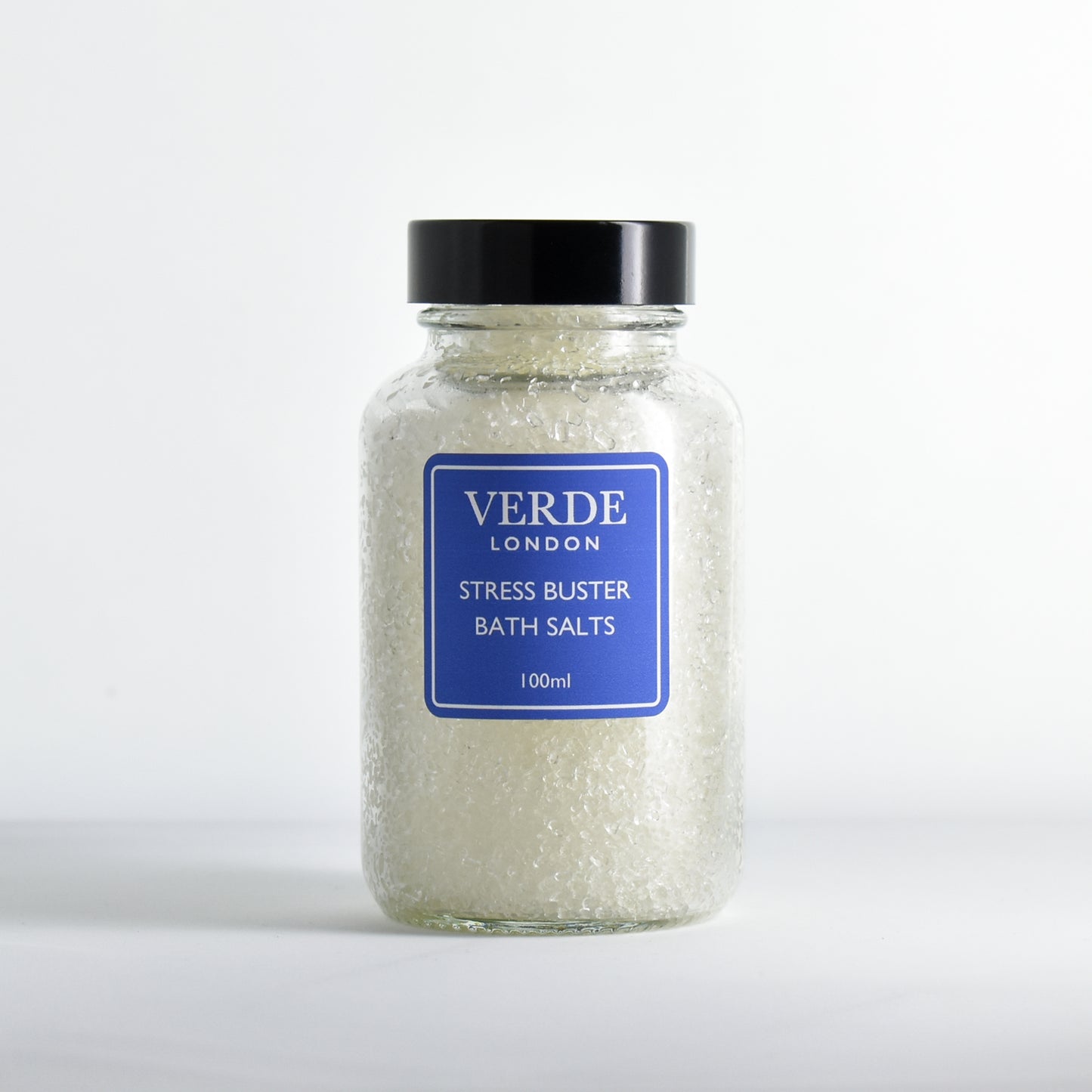 Glass jar of Verde London stress buster bath salts on a white background
