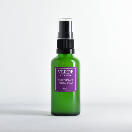 Green glass bottle of 'Verde London' Sweet Dreams Pillow Spray with purple label on a white background